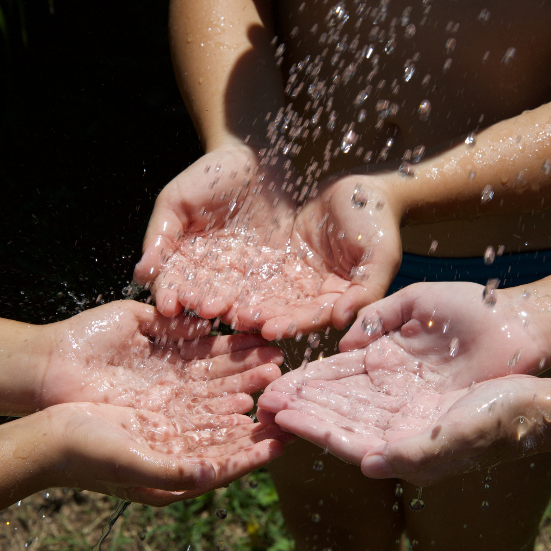 Hands cupped collecting water